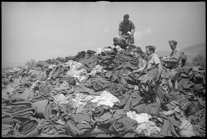 Pile of winter clothing handed in by 2 NZ Division personnel in exchange for summer clothing, Italy, World War II - Photograph taken by George Kaye