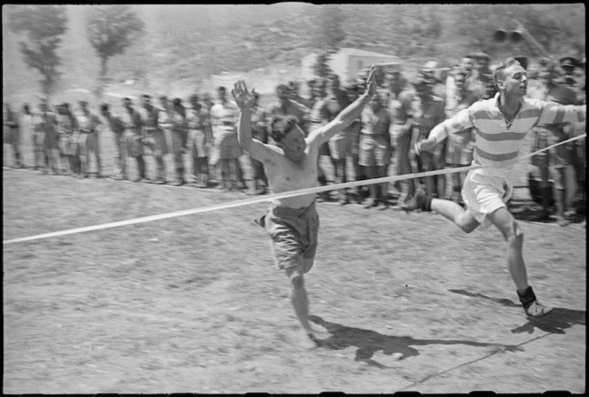 J P Gordon winning the 880 yards race at 5 NZ Infantry Brigade Sports Meeting in Italy, World War II - Photograph taken by George Kaye