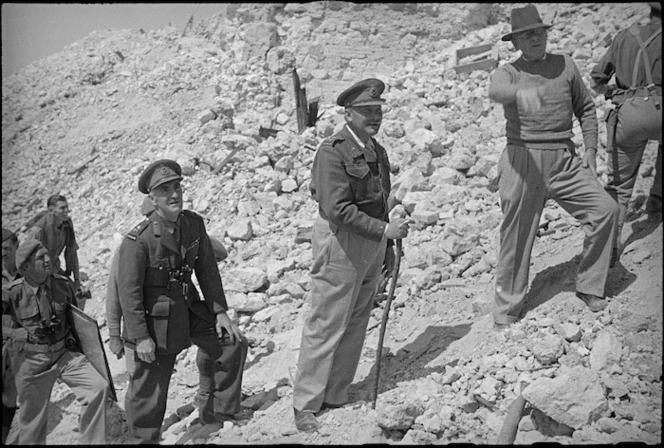 Prime Minister Peter Fraser pauses climbing Monastery Hill to ask General Bernard Freyberg a question about the recent fighting there, Cassino, Italy, World War II - Photograph taken by George Kaye