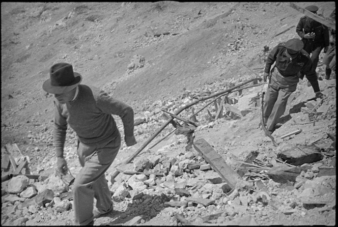 Prime Minister Peter Fraser ascends steep slope of Monastery Hill, Cassino, Italy, World War II - Photograph taken by George Kaye