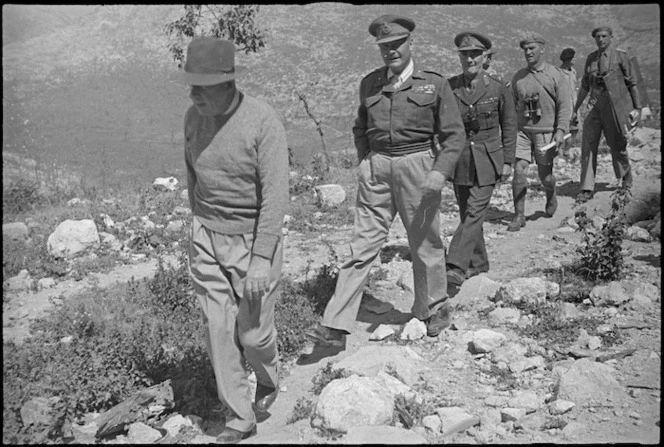 Prime Minister Peter Fraser, accompanied by General Bernard Freyberg and senior officers, climbing Monastery Hill, Cassino, Italy, World War II - Photograph taken by George Kaye