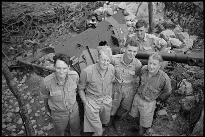 D K Sutherland prepares 25 pounder shell ready for firing in NZ Divisional Artillery gun pit on Cassino Front, Italy, World War II - Photograph taken by George Kaye