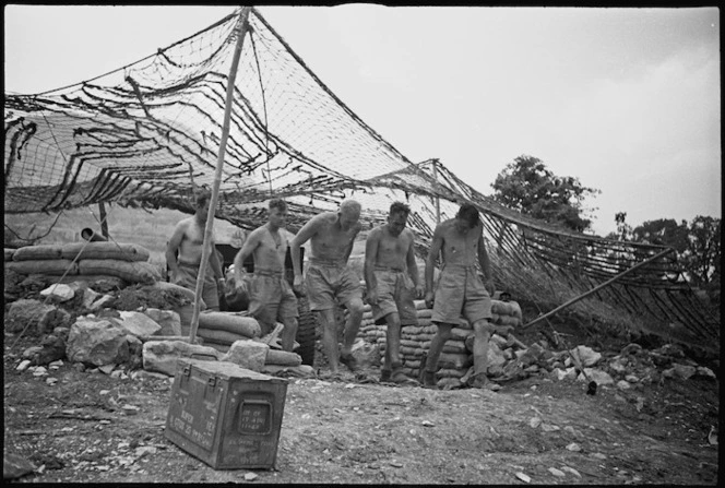 Gunners of NZ Divisional Artillery leaving gun pit after a shoot in the Cassino area, Italy, World War II - Photograph taken by George Kaye