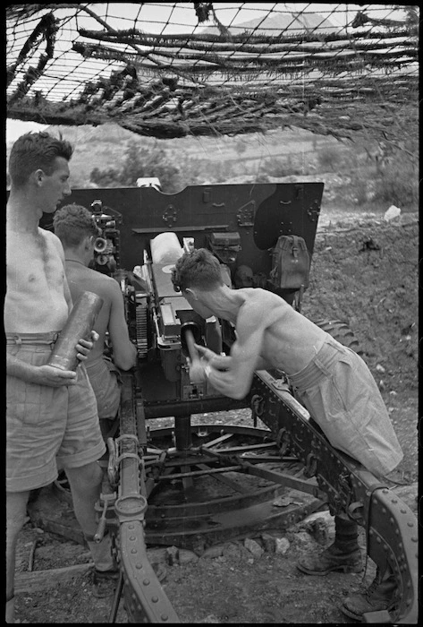 A shell is rammed home by gunners of the NZ Divisional Artillery in the Cassino area, Italy, World War II - Photograph taken by George Kaye