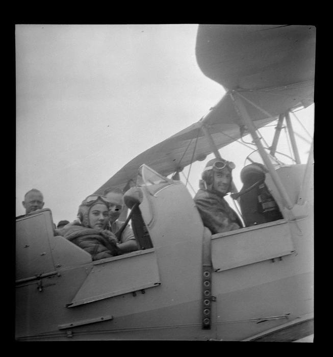 Portrait of Mr K Robinson and Miss Henny Van Polanan Petel in a Tiger Moth aircraft, at Mangere, Auckland