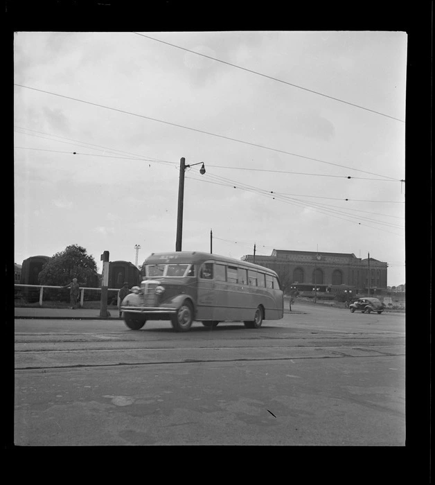 View of Johnston's Airways Transport Kiwi 2 bus leaving Auckland Railway Station for Mangere Airfield