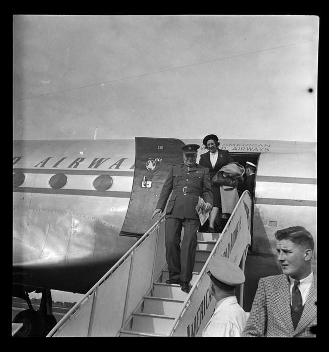 Brigadier A B Williams, Commandant Military Northern District, disembarking from a Pan American Airways Clipper Class Cathay DC4 passenger plane Good Will Flight, Whenuapai Airfield, Auckland