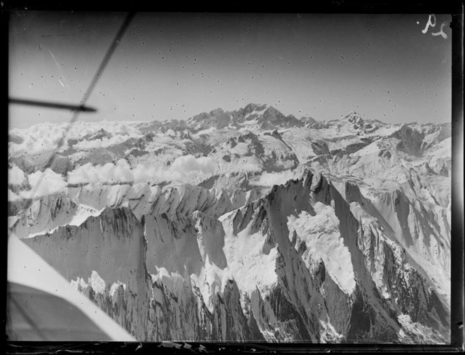 Biplane in flight over Mount Aspiring, Southern Alps