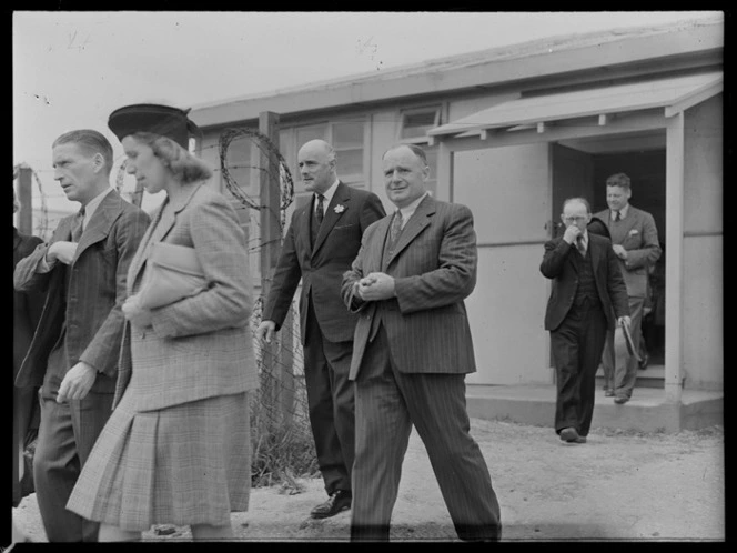 Group including E Mullane, Mrs B Mackenzie, Sir Patrick Duff, and Mr Roberts, at an unidentified location