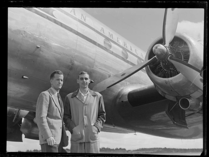 Portrait of (L to R) Mr Fulton and Mr Campbell, American athletes, in front of a Pan American Airways Clipper Class plane, Whenuapai Airfield, Auckland
