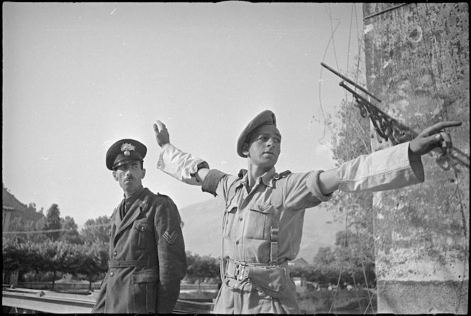 New Zealand Provost R H Blake on duty at the bridge across the Liri River at Sora, Italy, World War II - Photograph taken by George Kaye
