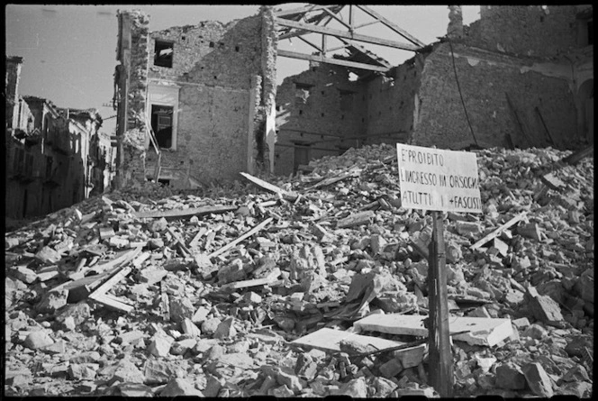 Notice forbidding the entry of Fascists set up in ruined street in Orsogna, Italy, World War II - Photograph taken by George Kaye