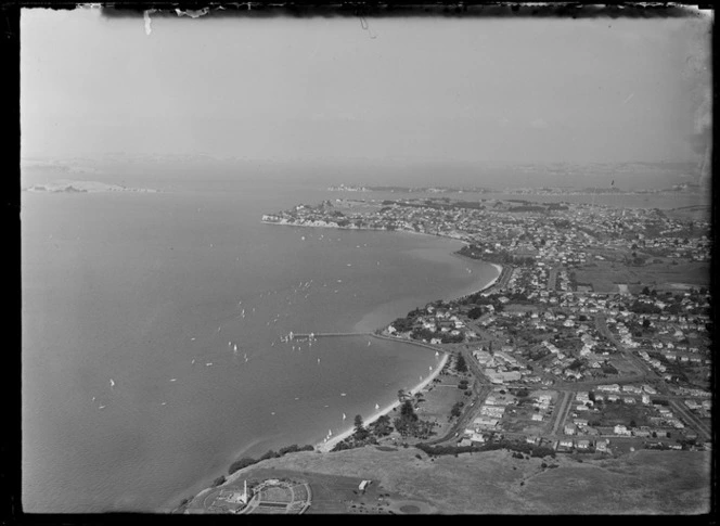 Mission Bay, Auckland, includes wharf, boats, shoreline, housing and farmland