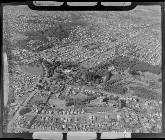 The North East Valley with Opoho Road, Knox College and the Dunedin Botanic Gardens mid-view, looking south to Dunedin City, Otago Region