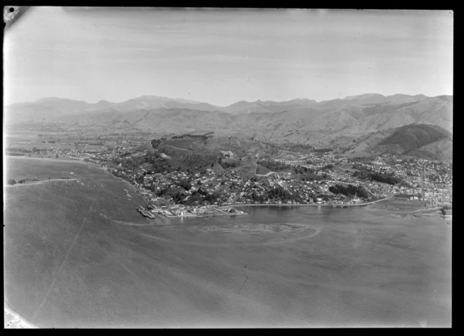 Nelson City and the hill suburb of Stepneyville with the Port of Nelson wharf and industrial area, with Tasman Bay and the Waimea Inlet beyond