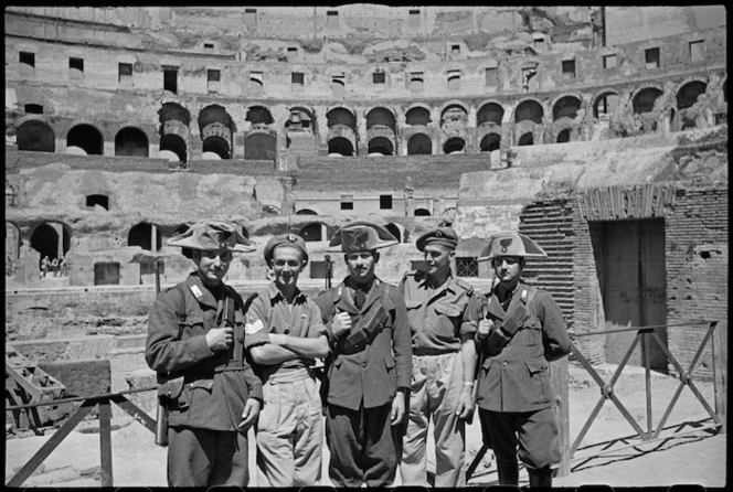 D W Madden and R W Bell with local carabinieri among ruins of the Colosseum, Rome, Italy - Photograph taken by George Kaye