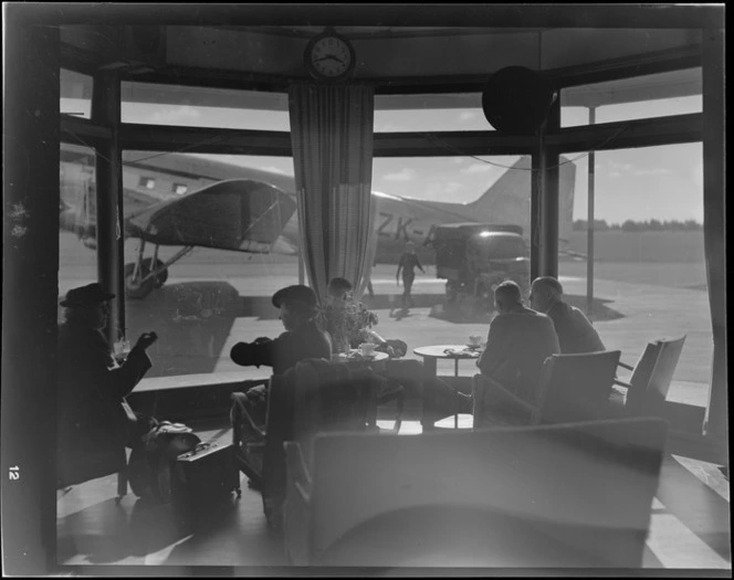 Interior view of passengers having a cup of tea after leaving a NZNAC (New Zealand National Airways Corporation) Dakota ZK-AOJ aircraft, Harewood airport, Christchurch