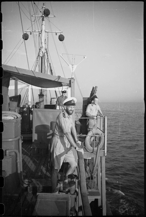 Lieutenant H L Mallitte and others watching sweep during World War II minesweeping operation in the Adriatic Sea - Photograph taken by George Bull