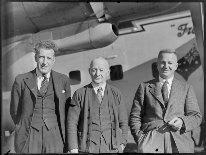 Mr R A Phillpots (Bank of New South Wales) (from left), N McDonald (Kaikohe Hotel) and L Mehrtens (Bank of New Zealand), in front of a Bristol Freighter aircraft