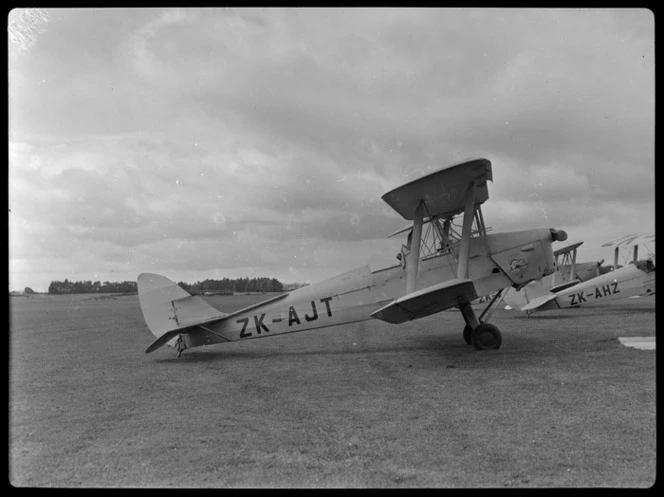 Tiger Moth ZK-AJT aeroplane, of Tauranga Aero Club, on ground at an unidentified aerodrome