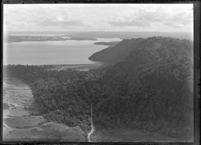 Otahuhu, Auckland City, showing bush covered hills near a beach