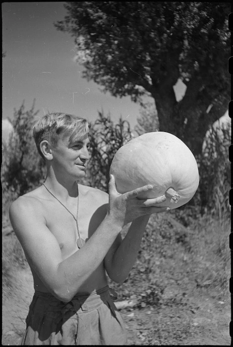 Cook, K J Truman, with locally grown pumpkin in the forward area Florence, Italy, World War II - Photograph taken by George Kaye