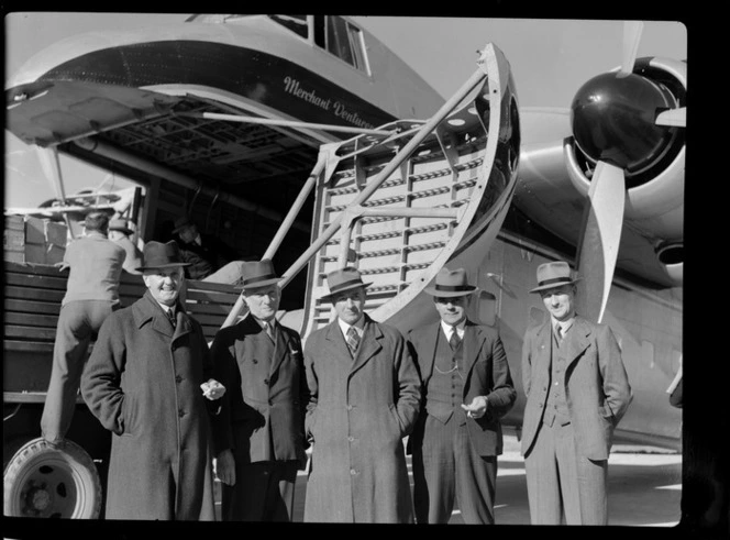 Bristol Freighter Tour, group portrait of Dunedin City Council and Otago Harbour Board Members in front of Bristol Freighter transport plane 'Merchant Venturer' G-AIMC, Taieri Airport, Dunedin District, Otago Region