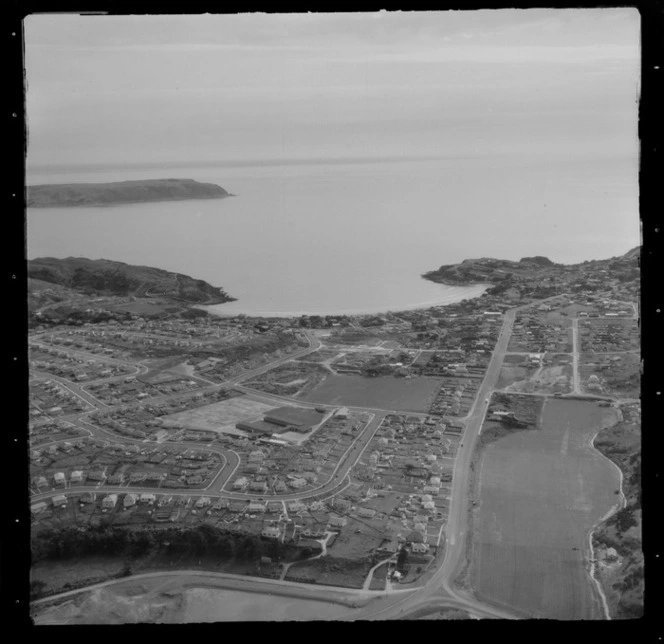 View of the Porirua suburb of Titahi Bay and Main Road with Onepoto and Kura Parks to Mana Island beyond, Porirua District, Wellington Region