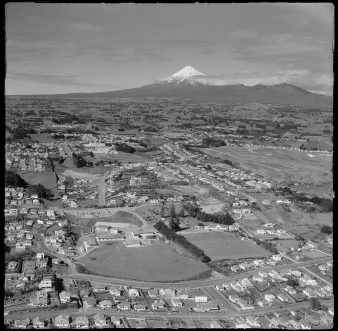 View over the New Plymouth City suburb of Lynmouth with Devon Intermediate School and St Joseph's Primary Schools to Taranaki Base Hospital, with farmland and Mount Taranaki beyond