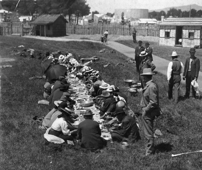 Unidentified group at a meal table during the International Exhibition, Christchurch