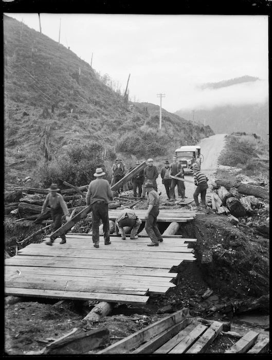 Men repairing a washed out bridge