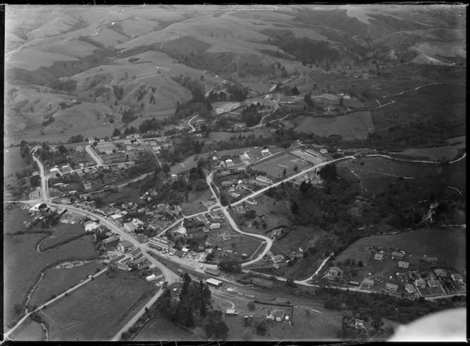 The town of Kawakawa with Railway Station and State Highway into Gillies Street with Wallace Supplies shop, surrounded by hilly farmland, Northland Region