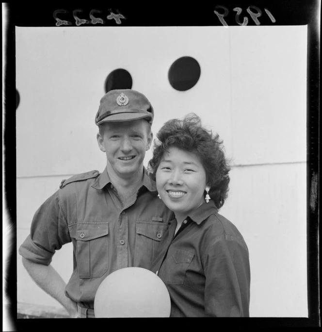 Malayan bride Nancy with her husband Private Laurie McGifford, on Glasgow Wharf, Wellington, after the return of the New Zealand Army from Malaya