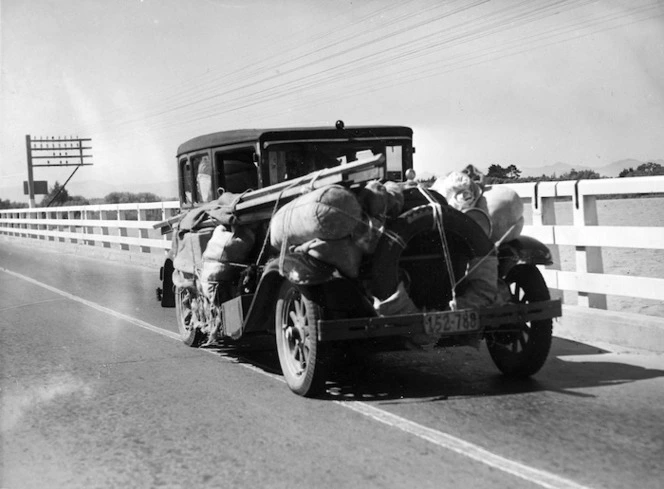 Motor car with packages roped on to the outside