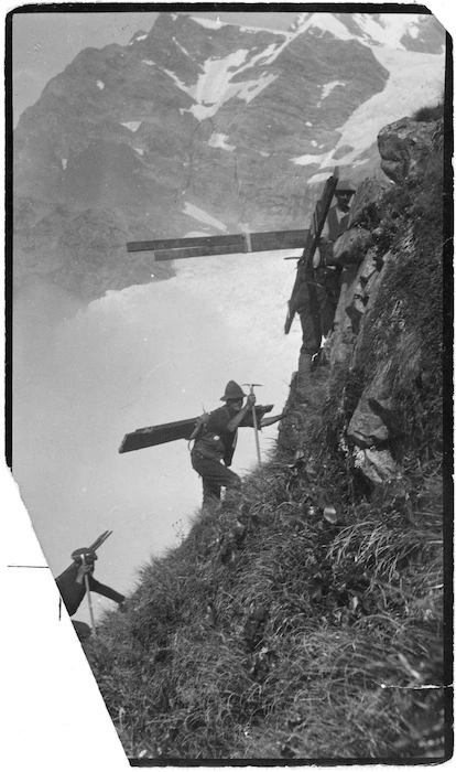 Carrying timber towards Haast Ridge for building Haast hut