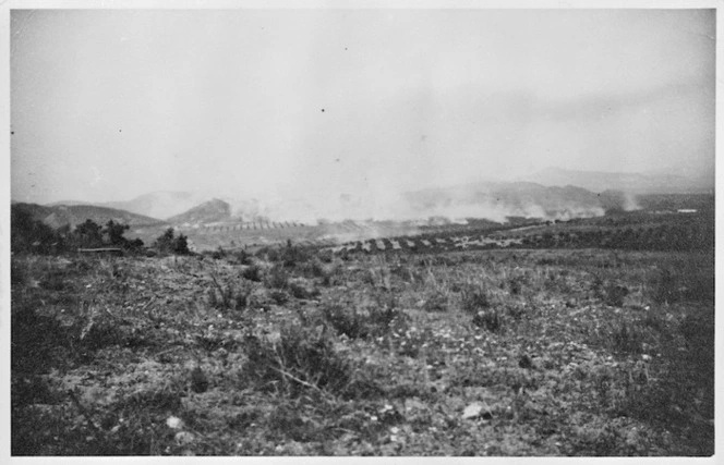 Scene in Tunisia, near Enfidaville, with tanks in the distance firing at enemy lines