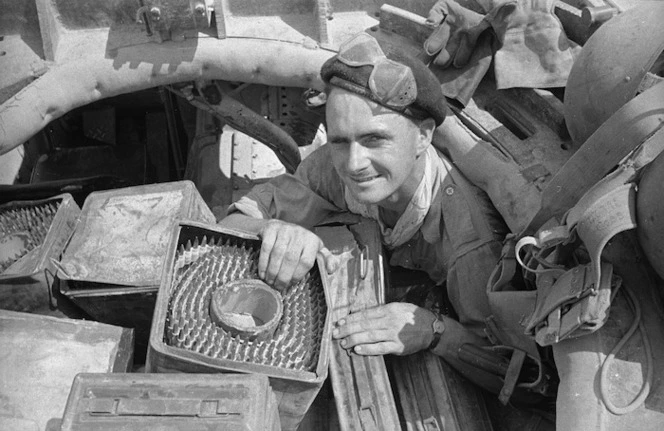 D O Long packing machine gun ammunition into a gun carrier during the advance to Florence, Italy