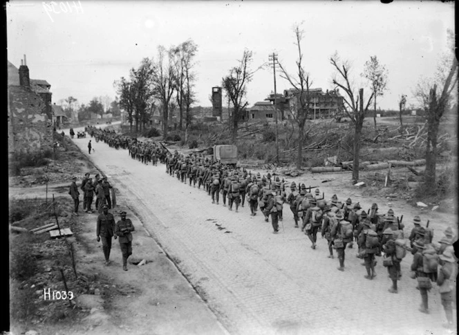 A New Zealand battalion passing through Bapaume, France, to rest