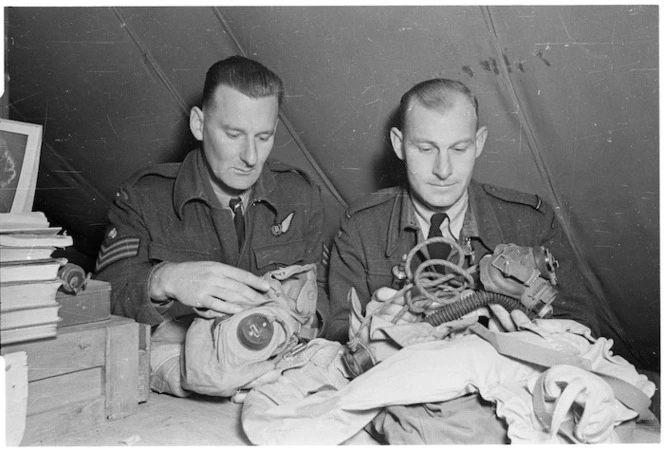 New Zealanders of the Royal Air Force checking their equipment before a flight, Foggia airfield, Italy - Photograph taken by George Kaye