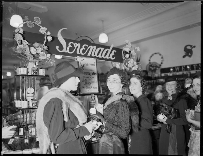 Women in a department store, alongside a display of Serenade beauty creams