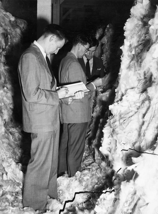 Three men classing wool before a sale