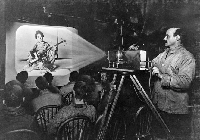 Herbert Ponting showing slides during his lecture on Japan, Antarctica