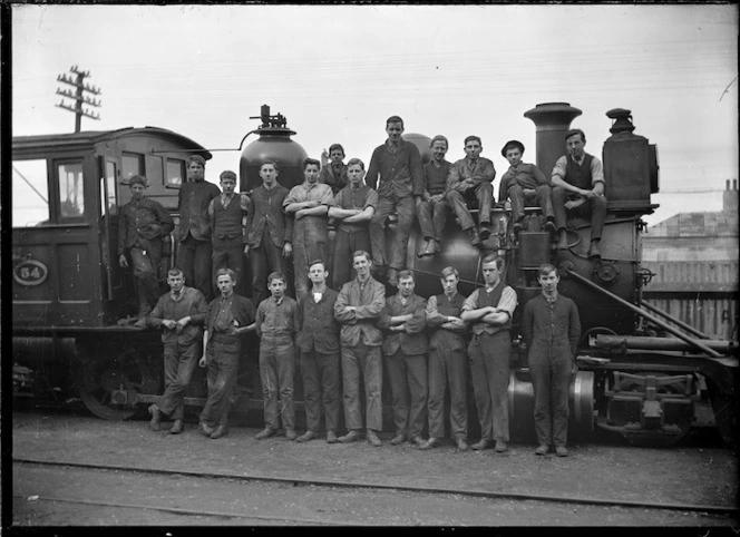 O Class steam locomotive NZR 54, 2-8-0 type, with a group of men on and beside the engine.