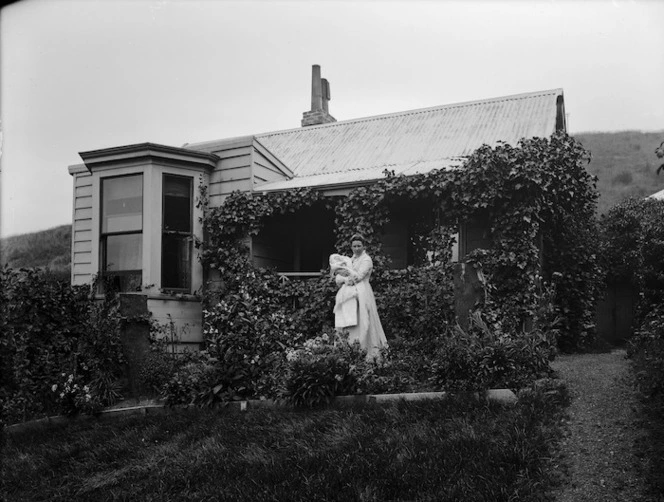 Lydia Williams holding her baby son Edgar, in the garden outside her house Viewbank on Maitland Street, Dunedin