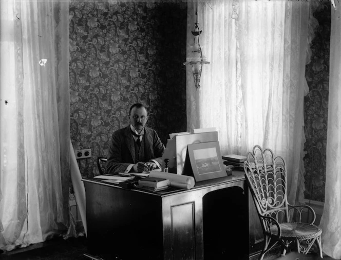 Governor of New Zealand, Lord Ranfurly, seated at a desk in Government House, Auckland