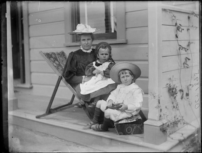 Portrait of Lydia Williams with sons (L to R) Owen and Edgar sitting on the veranda of their home at Royal Terrace in the suburb of Kew, Dunedin City