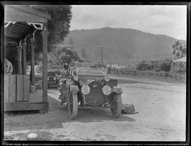 Three Cadillac [Model 30?] Touring Cars with three unidentified women outside an unknown General Store location with forest covered hill behind, [West Coast Region?]