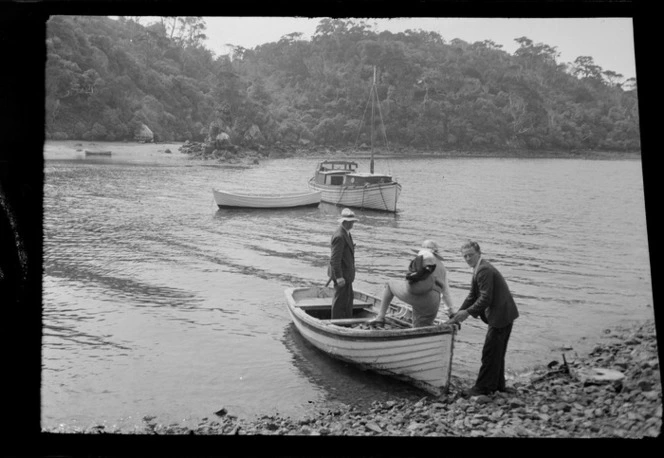 Edgar and Alice Williams in a row boat with unidentified man holding side of boat in unidentified bay, Stewart Island (Rakiura)