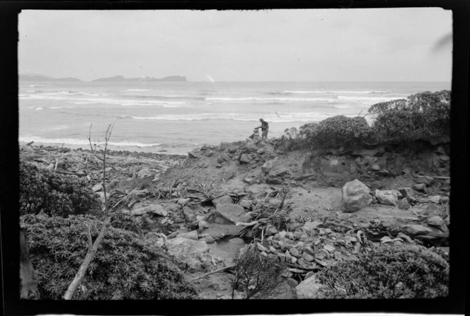 Alice Williams creating a pile of rocks, unidentified beach, Stewart Island (Rakiura)