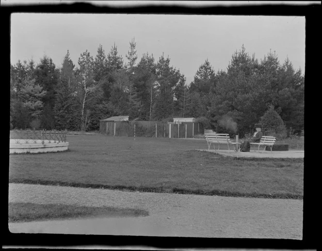 Lydia Williams sitting on park bench in grounds of tea kiosk and bath house, Hanmer Springs, Canterbury Region